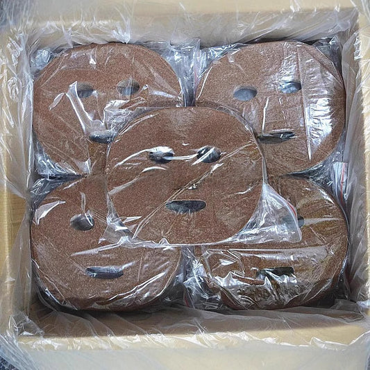 Packaged sandpaper discs in a box with clear plastic wrap.