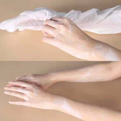 Transparent plastic gloves being worn on hands against a beige background