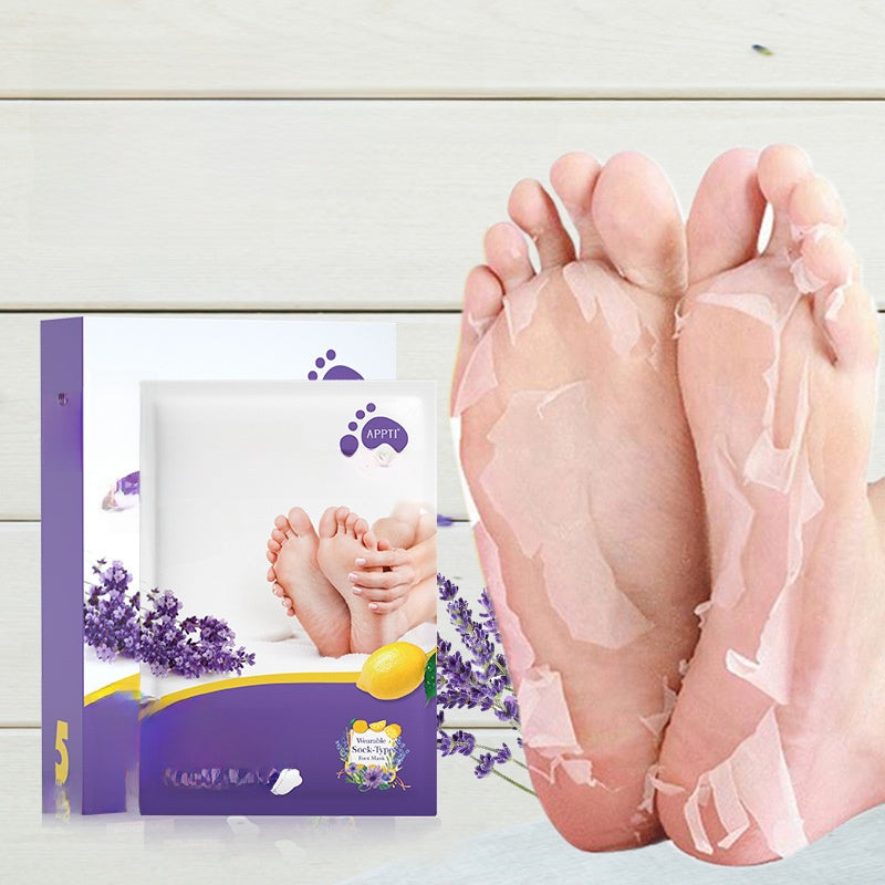 Foot peeling mask packaging with a pair of feet applying the mask on a light wooden background.